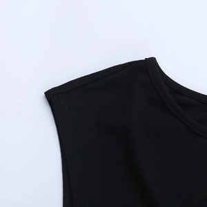 Close-up of black one-shoulder top with intricate lace stitching and cutout neckline