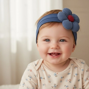 Close-up of blue baby nylon headband with a corduroy flower detail on an infant