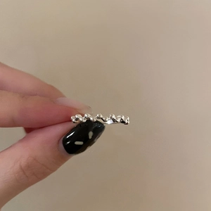 Macro side view of silver geometric wave ring with beaded texture and minimalist finish