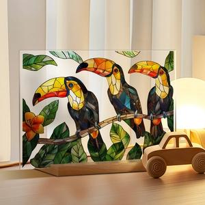 Detail of toucan stained glass art on acrylic panel with a minimalist wooden base