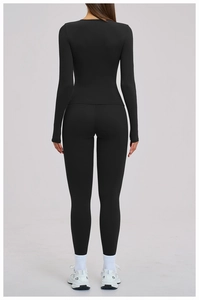 Back view of a black long-sleeve yoga set showing slim-fit athletic leggings and top