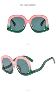 Macro detail of oversized square sunglasses with pink to green gradient frames