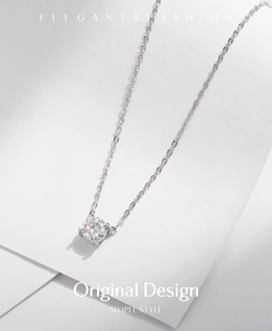 Detail view of simple S925 silver necklace with sparkling four-claw moissanite pendant