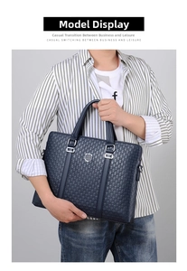 Detail of navy blue business briefcase with embossed patterns and silver metal shield logo