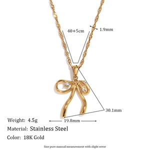 18K gold plated stainless steel bow necklace with sparkling crystals on white background