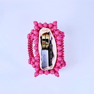 Internal view of pink beaded handbag showing capacity for phone and cosmetics