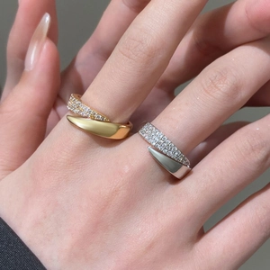 Elegant gold and silver open rings with inlaid zircon stones on a model's hand