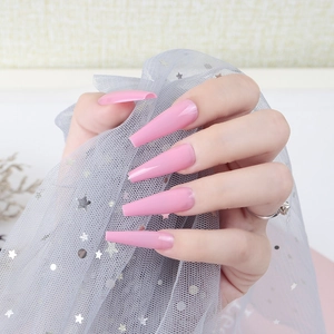 Glossy vibrant pink long coffin press-on nails with UV finish on hands
