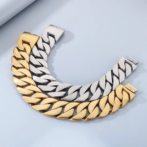Flat lay of 43mm wide Cuban link necklaces in polished gold and silver metallic finishes