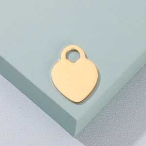 Detailed view of a polished gold-plated heart-shaped pendant with top mounting hole