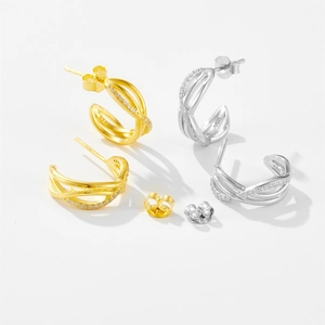 Detail view of gold and silver S925 sterling silver earrings with micro-inlaid zircon