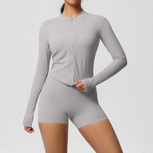 Detail of light gray yoga set featuring zip-up jacket with thumbholes and high-waist shorts