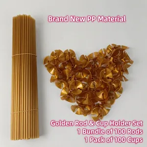 Detail of 100 golden plastic balloon sticks and cup holders arranged in a heart shape