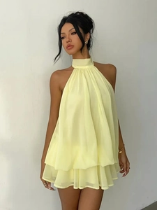 Detail of light yellow halter chiffon mini dress with tiered ruffle layers and A-line cut