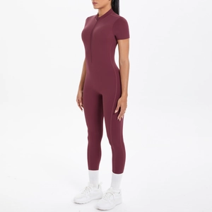 Detail of burgundy short sleeve fitness jumpsuit featuring front zipper and stand collar