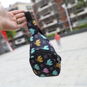 Detail of black nylon chest bag with colorful cartoon bird print and zipper closure
