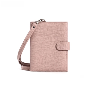 Detailed view of pink lychee grain leather wallet with wrist strap and silver buckle