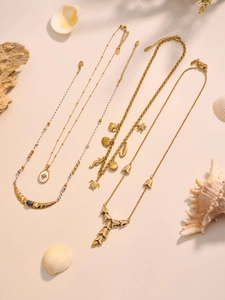 Detailed view of ocean series necklaces with seahorse and turtle charms in gold finish