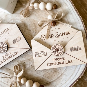 Laser-cut wooden envelope ornament with Mom's Christmas List engraving and bells