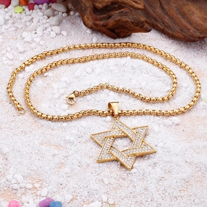 Close-up of gold hip hop hexagram star pendant necklace with sparkling rhinestones
