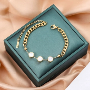 Minimalist gold titanium steel bracelet featuring triple mother-of-pearl circular charms