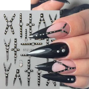 Detail of 5D embossed nail stickers featuring dark punk silver studs and cross designs