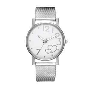 Detail of silver mesh band women's watch featuring a white dial with heart design