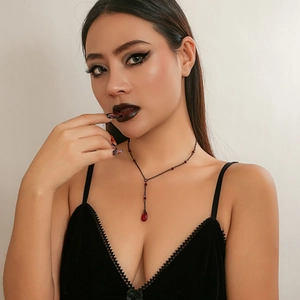 Close-up of gothic blood tassel necklace with red crystal droplet and black chain links