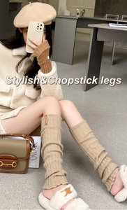 Detail view of khaki cable knit leg warmers with soft wool texture for winter style
