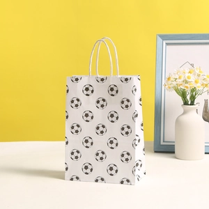 Soccer pattern kraft paper gift bag with white rope handles on a bright studio background