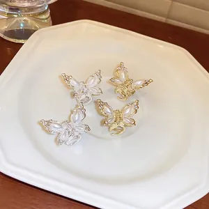 Mini butterfly hair clips with cream pearls and sparkling rhinestones in gold and silver