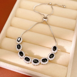 Detail of silver adjustable bracelet with black oval stones and cubic zirconia