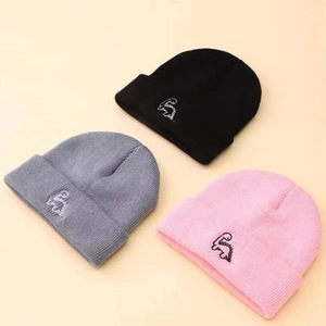 Three kids knit beanies in black, grey, and pink with cute white dinosaur embroidery