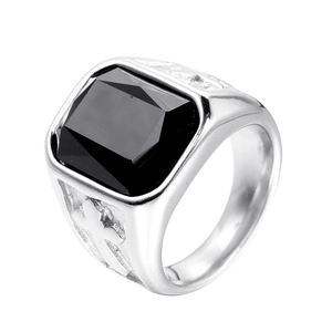 Detailed close-up of a men's stainless steel ring with black gemstone and cross engraving