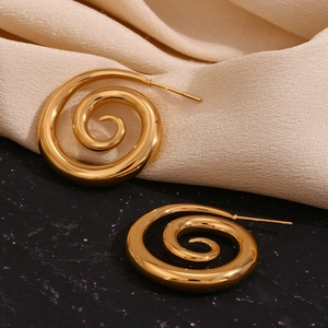 Macro view of 18K gold plated stainless steel earrings with creative spiral smoke design