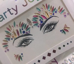 Detail view of colorful face gem stickers in teardrop shapes on paper packaging