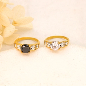 Luxe gold stainless steel rings featuring brilliant black and white zircon center stones