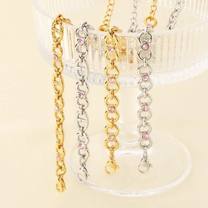 Detail of 8mm pink zircon bracelets with gold and silver links and pig nose charms