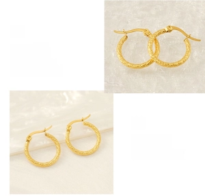 Detailed macro view of 18k gold-plated stainless steel hoop earrings with textured finish