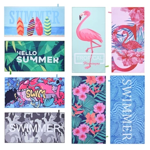 Detailed grid of colorful microfiber beach towels featuring flamingo and floral prints