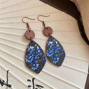 Bohemian leaf drop earrings with blue floral prints on wood elements for women