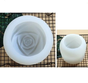 Detailed macro view of white cylindrical silicone rose flower candle and ice cube mold