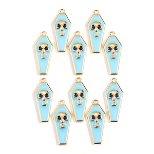 Detail of ten light blue coffin pendants with gold skull patterns for DIY jewelry