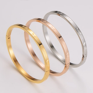 Detailed view of 4mm stainless steel bangles in gold, rose gold and silver with butterfly engraving
