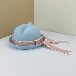 Detail view of light blue wool felt hat featuring cat ears and pink ribbon bow