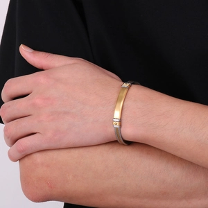 Mens stainless steel braided wire cable bracelet with gold bar and silver finish