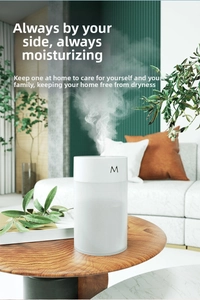 Close-up of a white minimalist USB humidifier on a wooden table in a cozy home setting