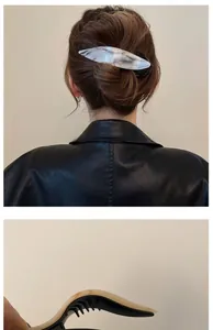 Detail of marble pattern acetate hair clip shown on model and in close-up view