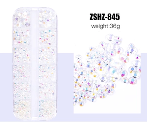 Macro detail of mixed sizes AB colorful flatback resin rhinestones in a 12-slot storage box