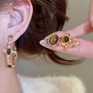 Detailed close-up of vintage golden tiger eye earrings with sparkling micro-inlaid rhinestones